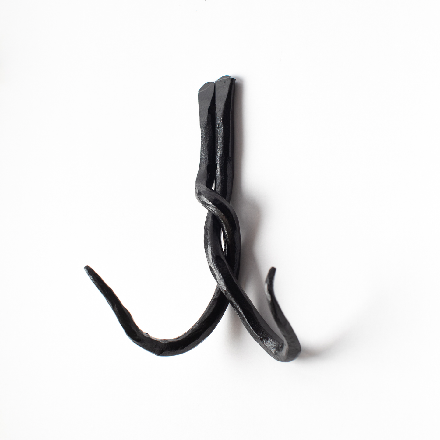 An Urban Forge Black River hand-forged iron double hook in a black finish. The hook is pictured against a white backdrop.