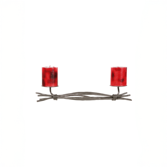An Urban Forge Black River hand-forged iron double candle holder in a black finish. It's pictured with two red candles against a white backdrop.