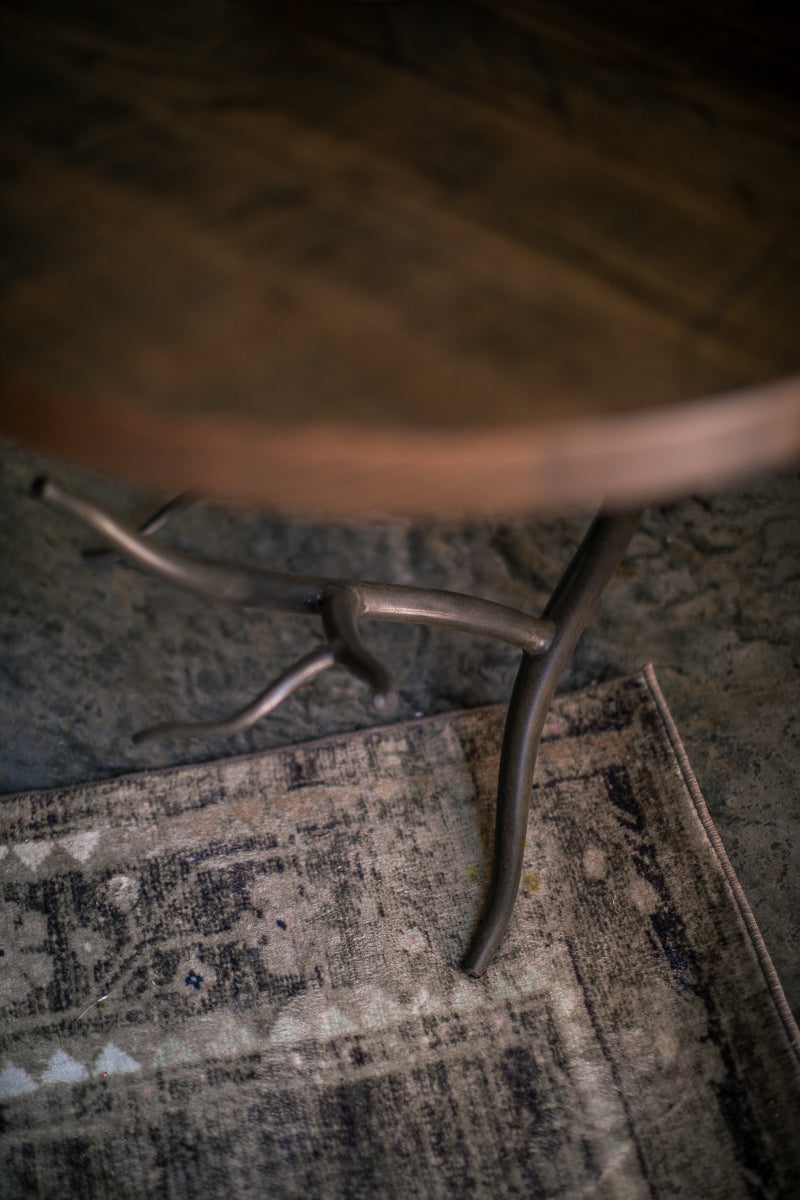 Close-up shot of the Urban Forge Driftwood side table branch design.