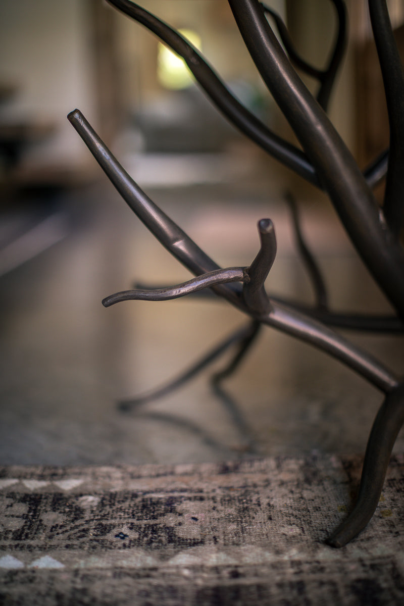 Close-up shot of the Urban Forge Driftwood side table branch design.
