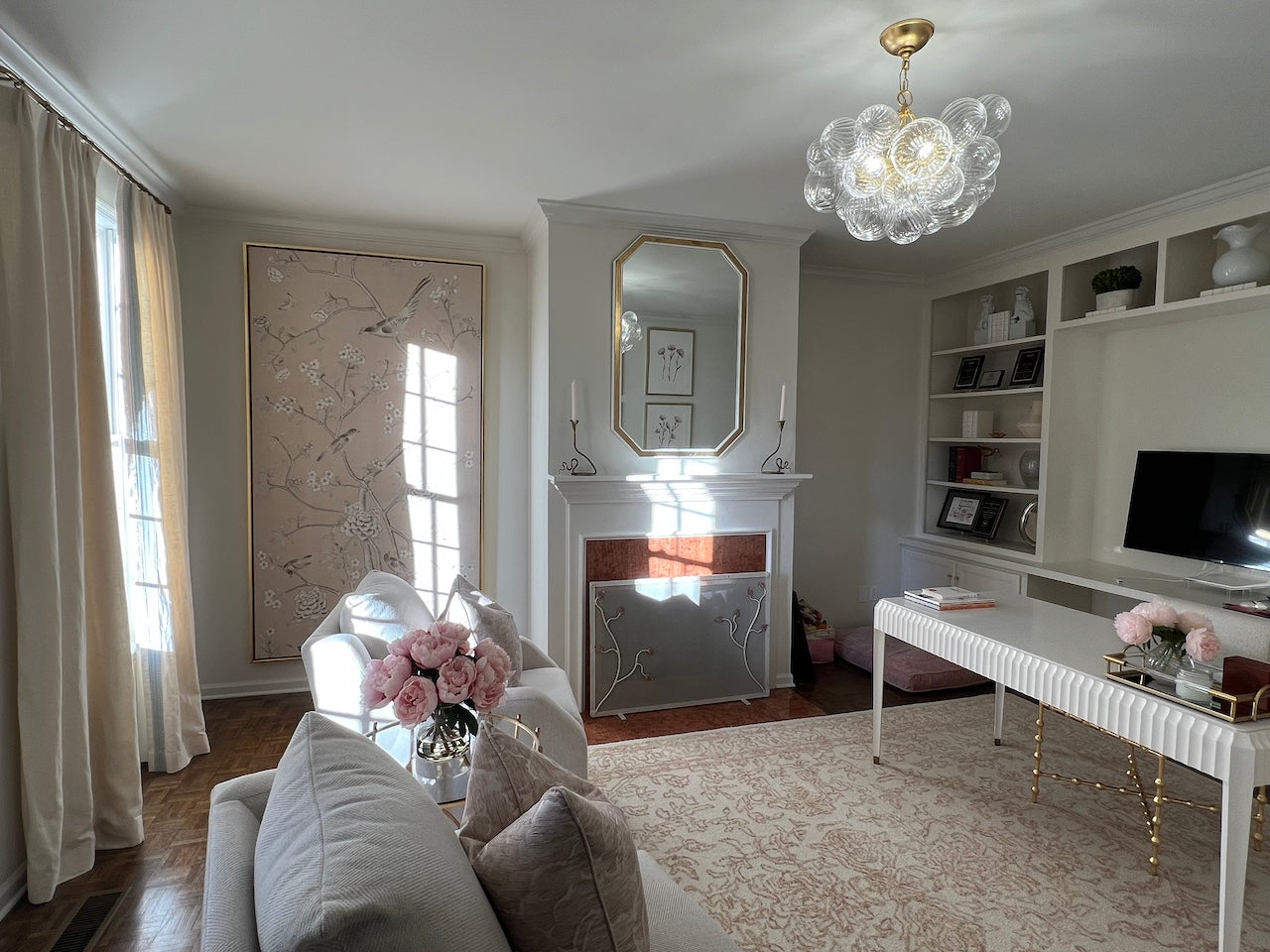 Two Urban Forge Ivy single candle holders are displayed on a hearth within a stunning home office decorated in white.