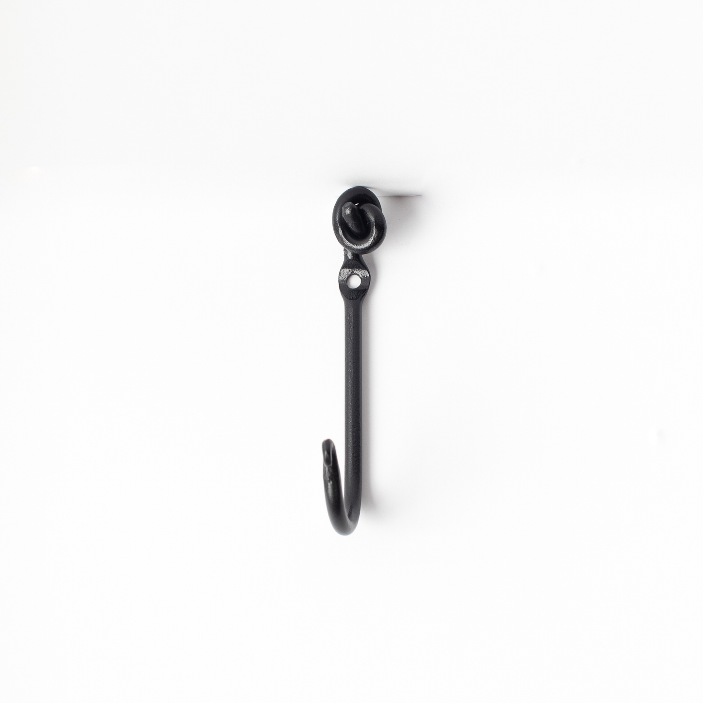 An Urban Forge Knot hand-forged iron single hook in a black finish. The hook is pictured against a white backdrop.