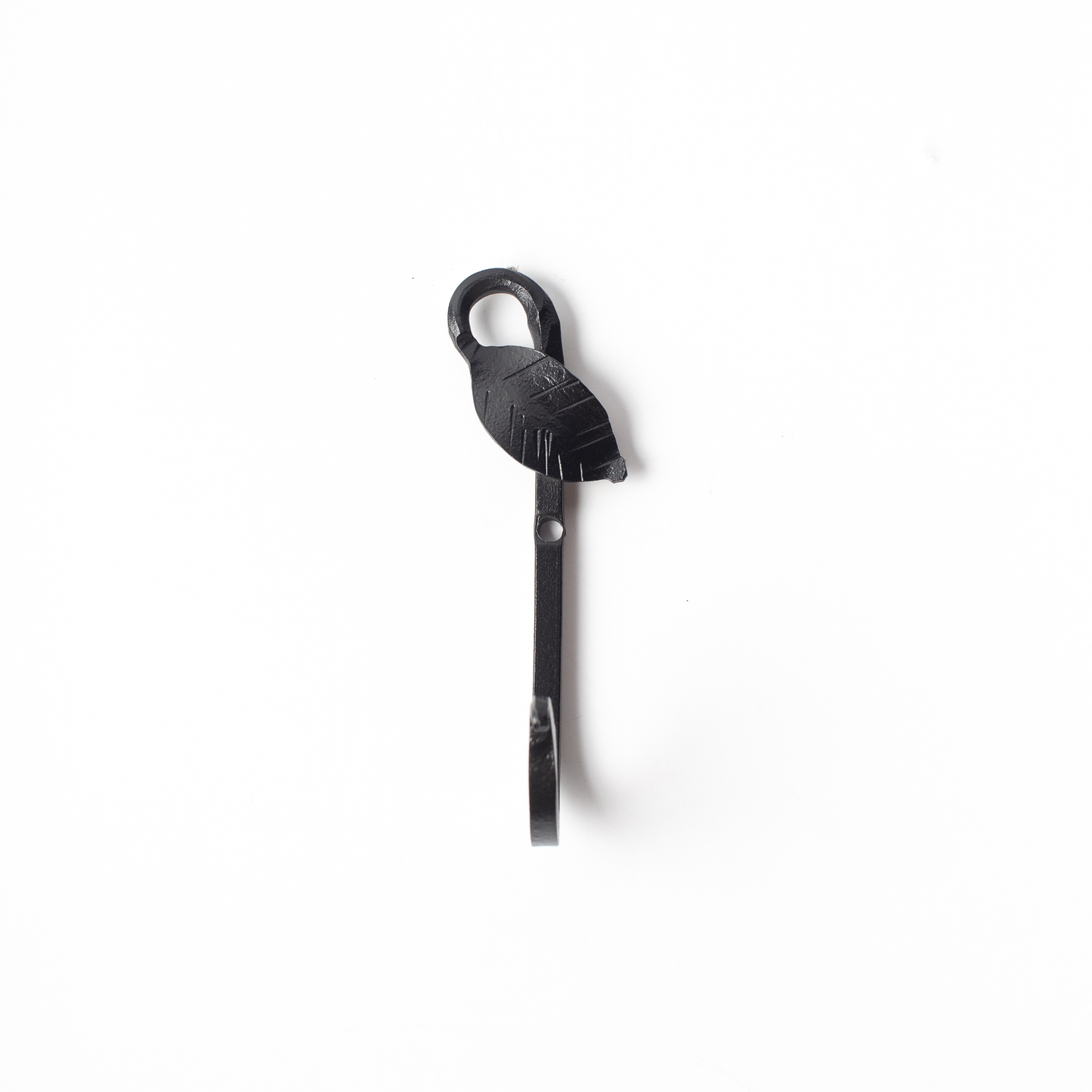 An Urban Forge Leaf hand-forged iron single hook in a black finish. The hook is pictured against a white backdrop.