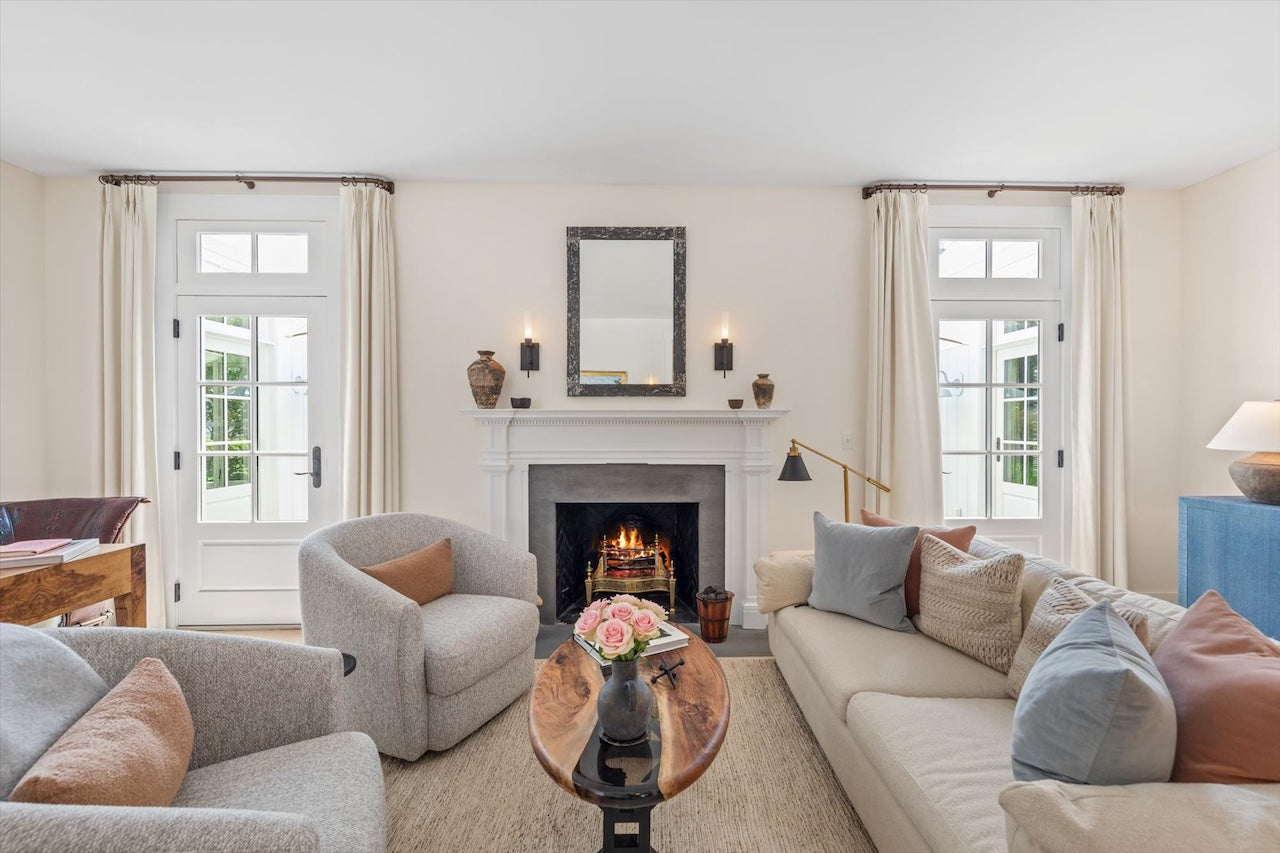 Living room with a fireplace, couches, and decorative items.