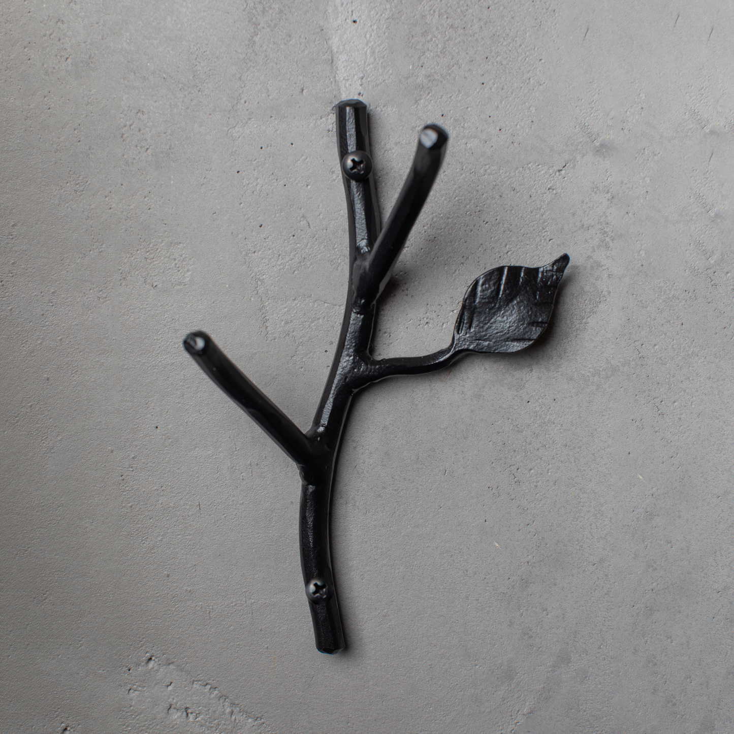 An Urban Forge Sylamore hand-forged iron double hook in a black finish. The hook is mounted on a gray wall.