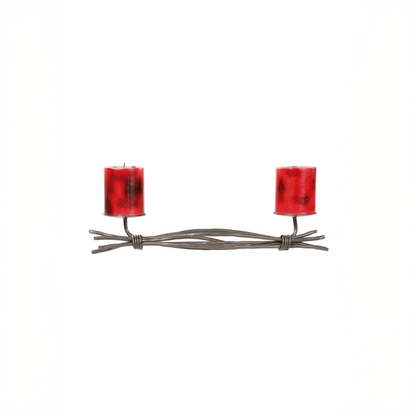 An Urban Forge Black River hand-forged iron double candle holder in a black finish. It's pictured with two red candles against a white backdrop.