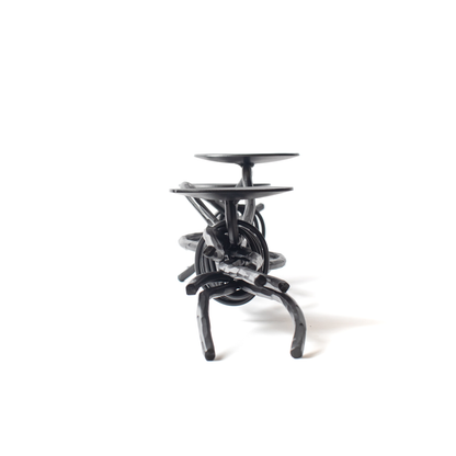 The Urban Forge Black River triple candle holder in a black finish. The candle holder is pictured against a white backdrop.
