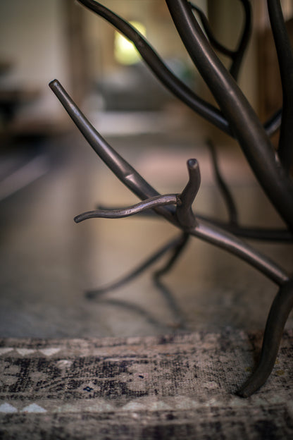 Close-up shot of the Urban Forge Driftwood side table branch design.