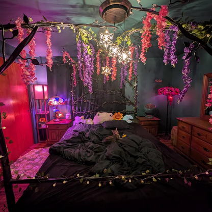 Decorative bedroom with floral arch, string lights, and colorful lighting.