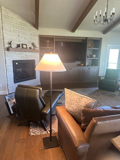 An Urban Forge Greenwood Stick floor lamp in a cozy living room.