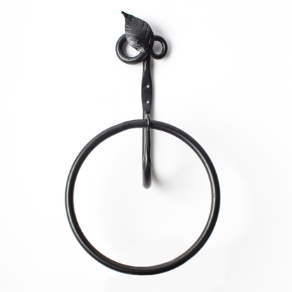 The Urban Forge Leaf towel ring in a black finish. The towel ring is pictured against a white backdrop.