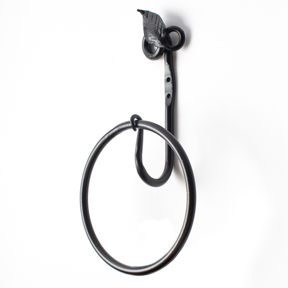The Urban Forge Leaf towel ring in a black finish. The towel ring is pictured against a white backdrop.