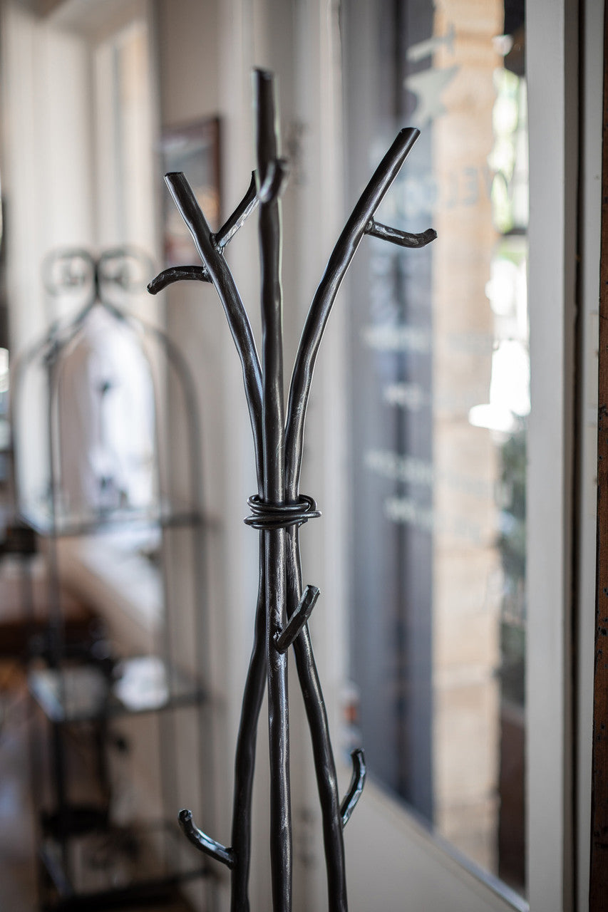 An Urban Forge Sylamore iron standing coat rack in a black finish.