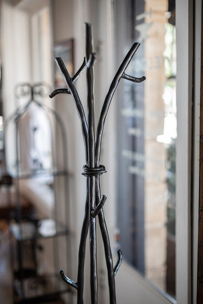 An Urban Forge Sylamore iron standing coat rack in a black finish.