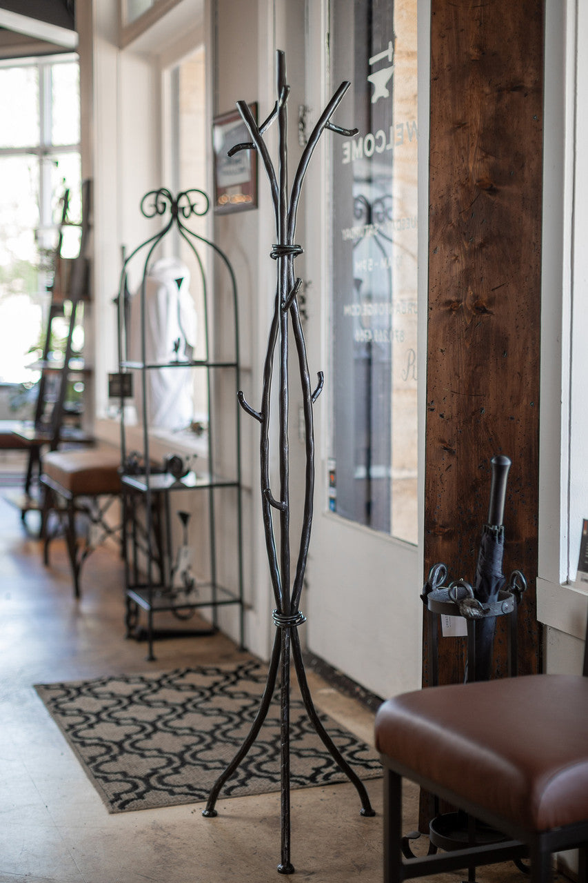 An Urban Forge Sylamore iron standing coat rack in a black finish.