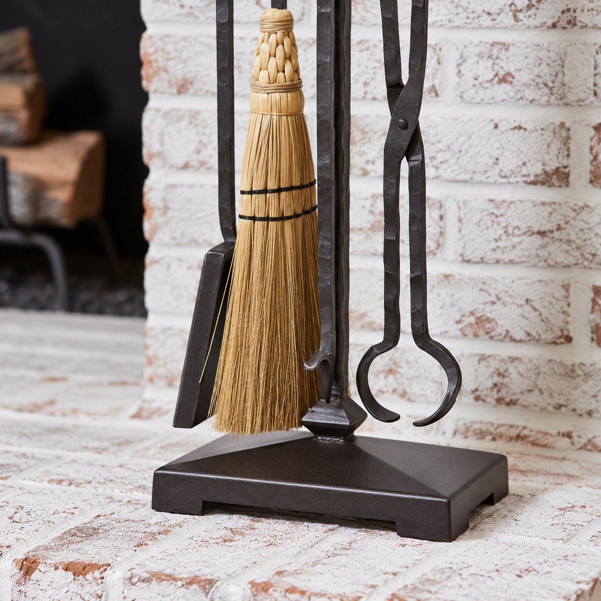 Blackwell fireplace tool set detail showing the hand-tied broom, forged tongs, shovel and stand base.