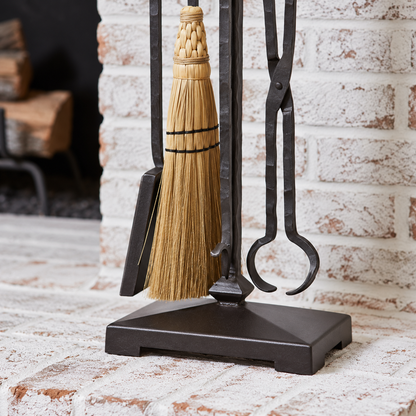 Blackwell fireplace tool set detail showing the hand-tied broom, forged tongs, shovel and stand base.
